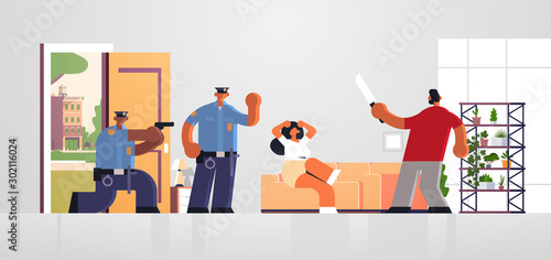 police officers pointing gun at thief with knife attacking woman policemen in uniform arresting burblar security authority justice law service concept living room inteiror full length horizontal