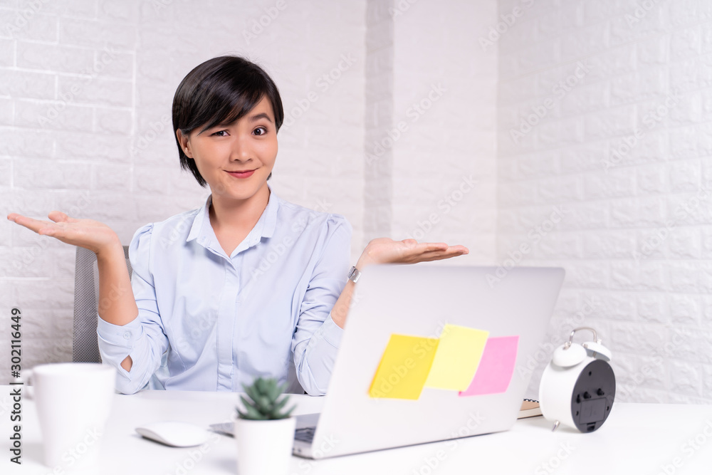 Portrait of a confused woman sitting at office Portrait of a confused woman sitting at office