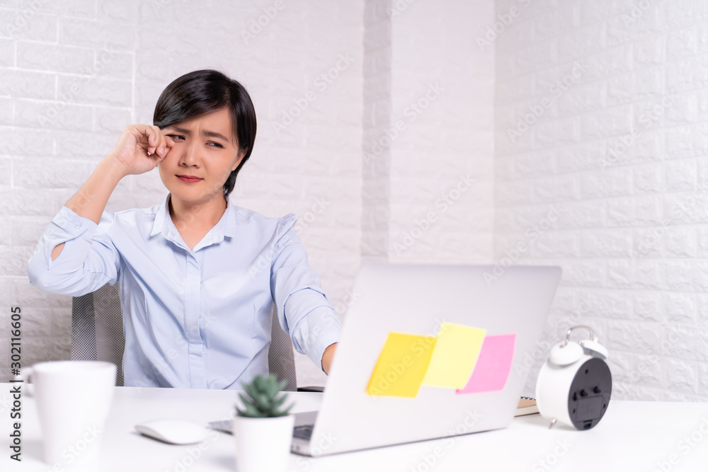 Sad woman sitting at home office working using computer laptop Sad woman sitting at home office working using computer laptop