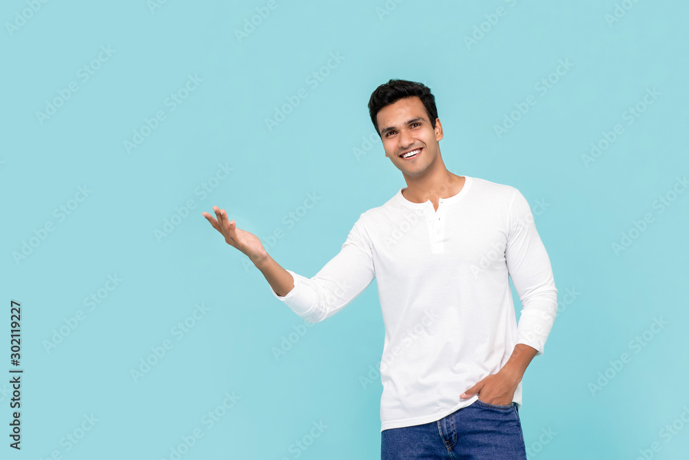 Young Indian man presenting with opened palm Young Indian man presenting with opened palm