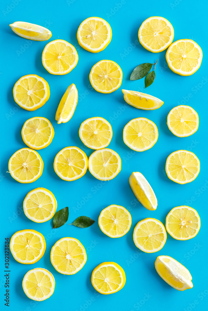Lemon and leaves pattern on blue background top view