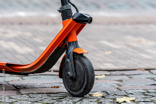 electric scooter front wheel close-up on the sidewalk pavement