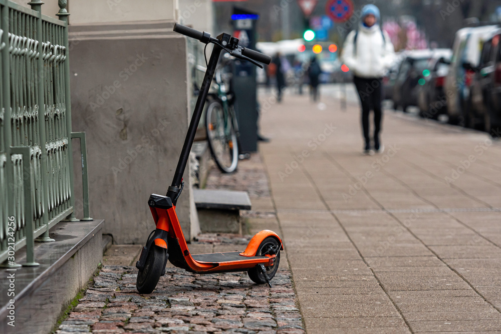 Obraz premium An electric scooter parked on the sidewalk in Riga, Latvia