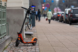  An electric scooter parked on the sidewalk in Riga, Latvia
