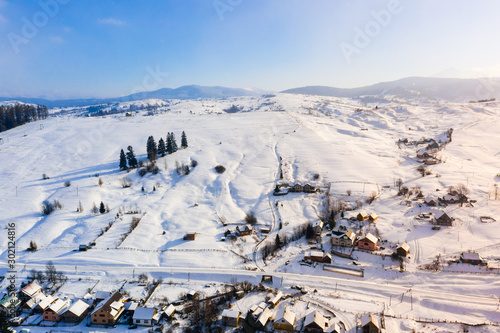 Bright sunny day begins in snowy mountains, aerial landscape. Winter recreation concept. Holiday time