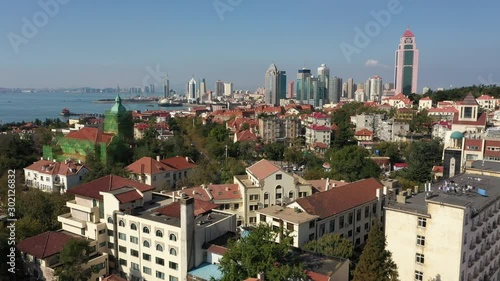 Slow drone flight of historic European (German) buildings mixed with contemporary apartment buildings in Qingdao, China photo