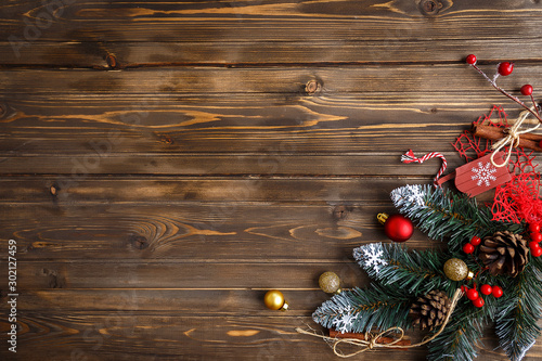 Fir branch with Christmas decorations on old wooden brown background with copy space for text photo