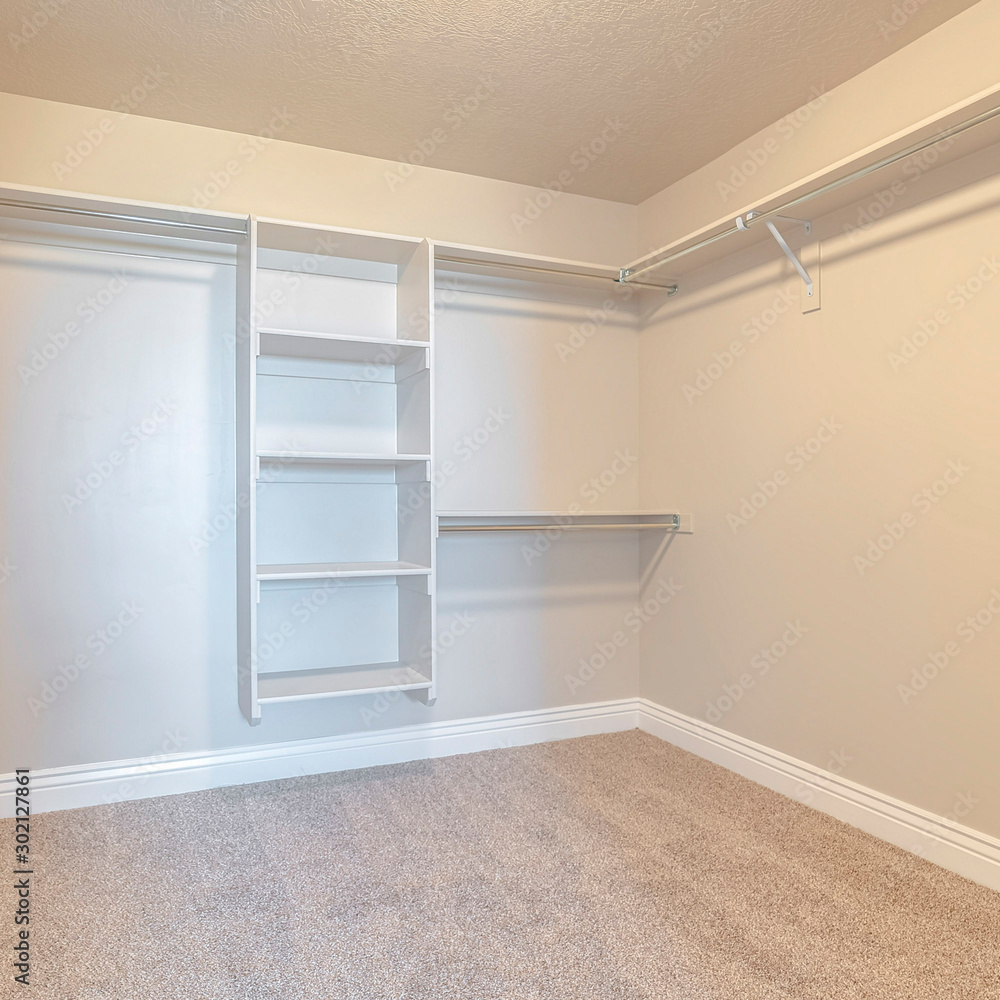 Fototapeta premium Square frame Empty white walk in closet with bare shelving