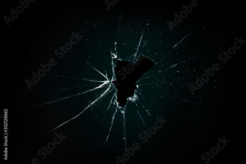 broken and cracked glass with hole