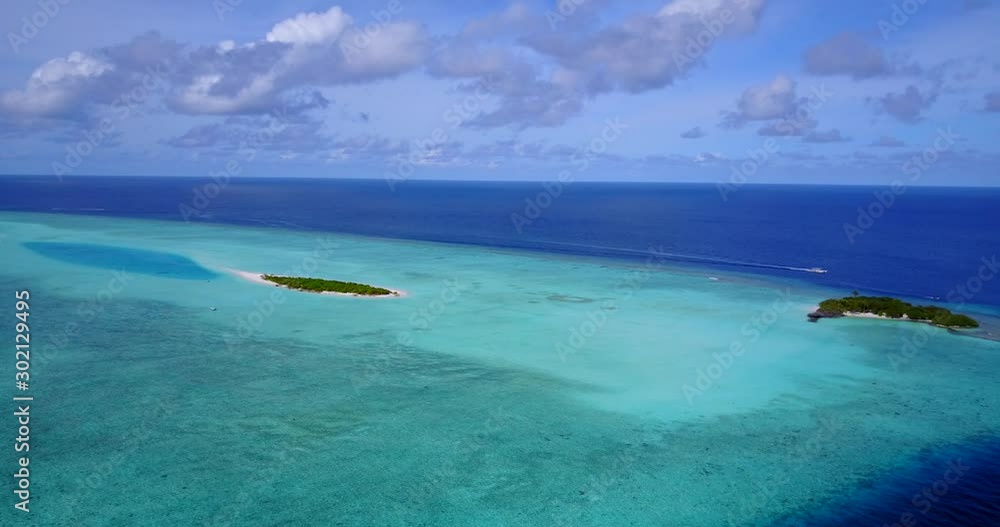 Bahamas, North America - Close Encounter Of The Green Shallow Ocean And Deep Blue Ocean Surrounding Small Islands Underneath The Cloudy Sky - Aerial Shot Bahamas, North America - Close Encounter Of The Green Shallow Ocean And Deep Blue Ocean Surrounding Small Islands Underneath The Cloudy Sky - Aerial Shot