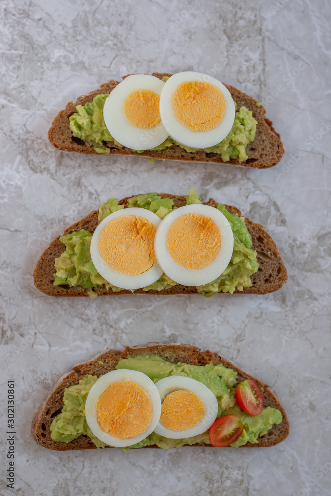 sliced avocado and egg on toasted bread for healthy breakfast sliced avocado and egg on toasted bread for healthy breakfast