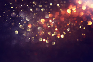 background of abstract glitter lights. gold and black. de focused