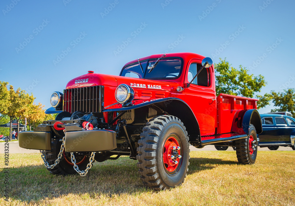 Front side view of a red vintage 1948 Dodge Power Wagon classic truck