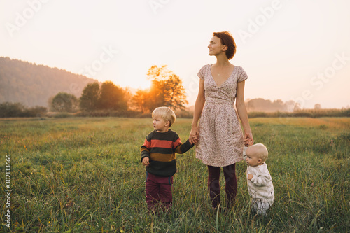 Obraz na plátne Family on nature. Mother with children outdoors.