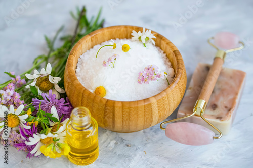Spa still life bath salt with essential oils and medicinal healing herbs   flowers and plants