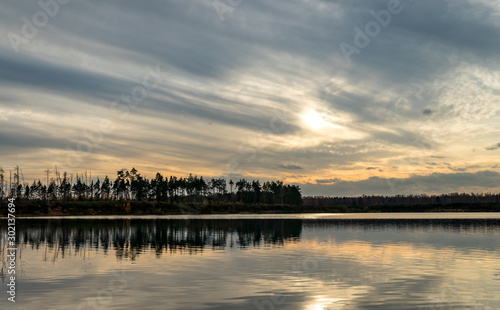 Evening landscape. Clouds over the lake. © ValerAnDim