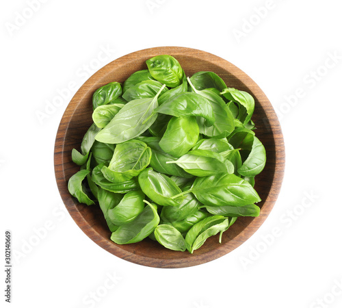 Fresh basil leaves in wooden bowl isolated on white, top view