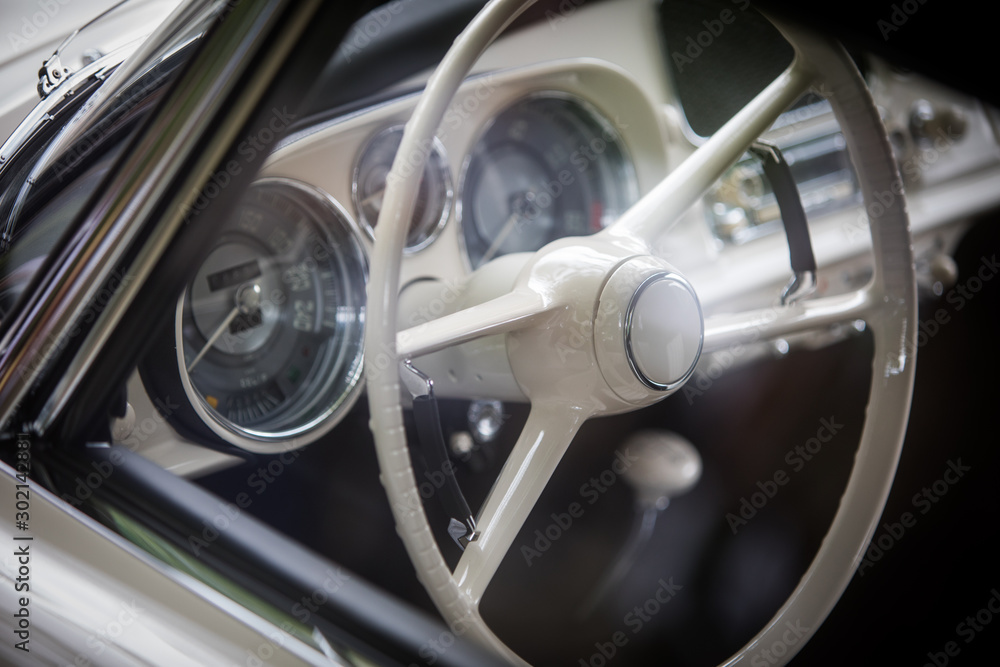 White steering wheel of an old classic car White steering wheel of an old classic car