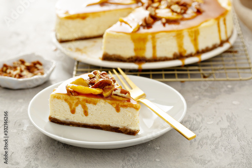 Photos Apple caramel pecan cheesecake with dripping sauce, a slice on a plate