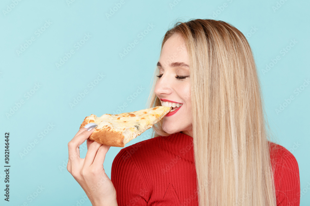 Happy girl with delicious pizza isolated over the blue background