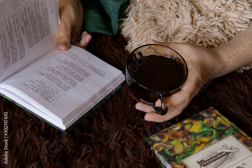Cozy reading poetry books on a soft blanket with a cup of hot tea