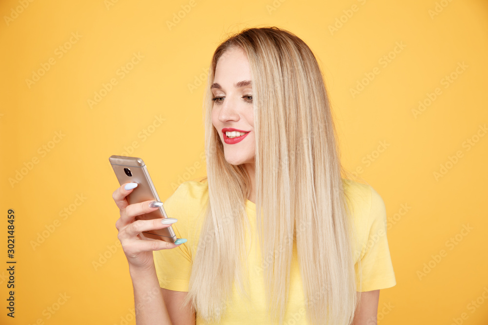 Happy blond woman using phone in the studio Happy blond woman using phone in the studio