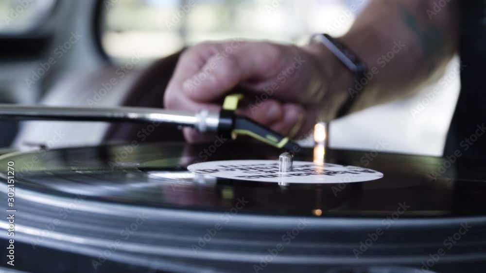 DJ playing music on a vinyl turntable at the club. Close up DJ playing music on a vinyl turntable at the club. Close up