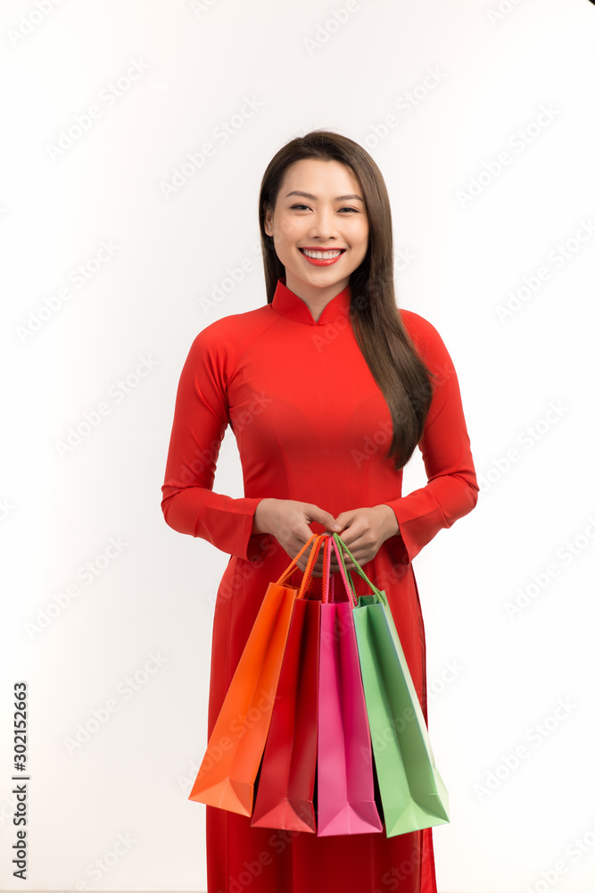 Beauty women wear ao dai and take shopping bag in lunar new year (tet holiday)
