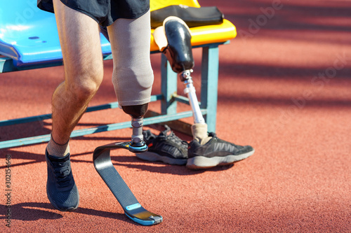 Amputee athlete is getting ready for a race. Runner with a prosthetic leg.