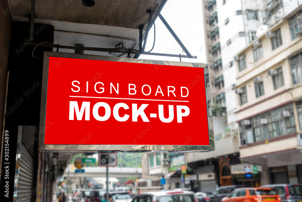 Obraz premium Mock up signboard hanging over street at front of shop