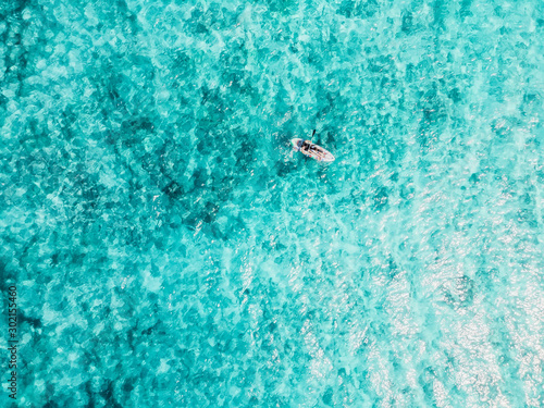 Tourists at kayak floating in transparent ocean. Aerial view