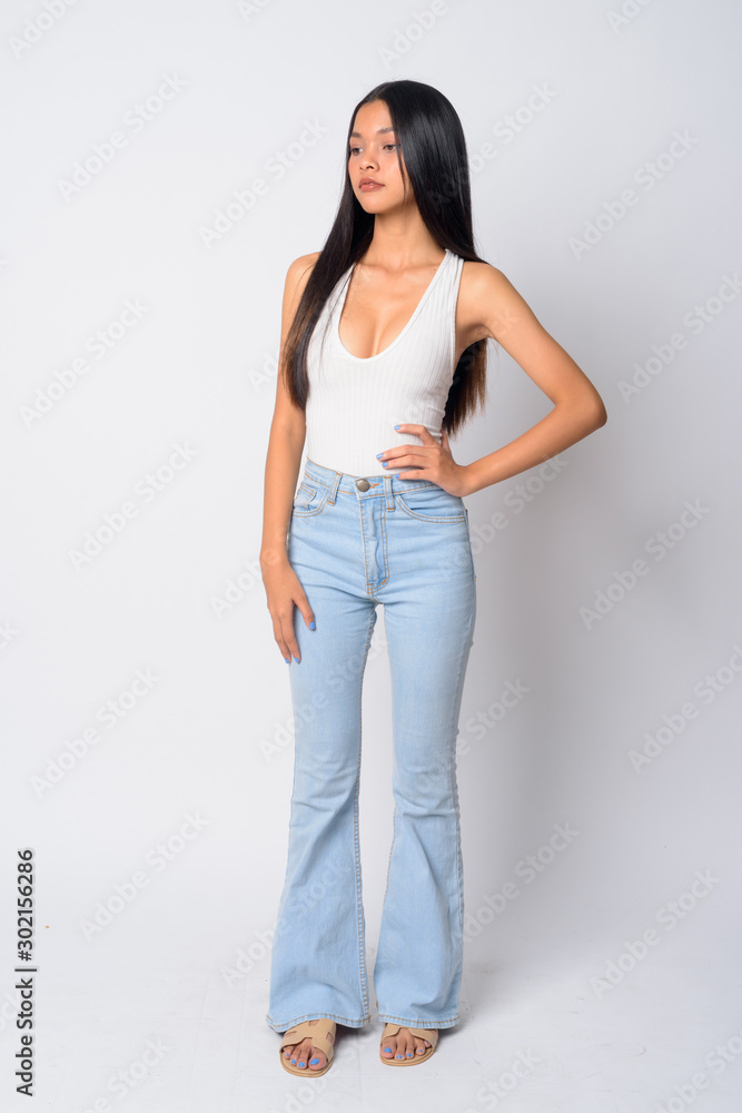 Full body shot of young beautiful Asian woman looking down Full body shot of young beautiful Asian woman looking down