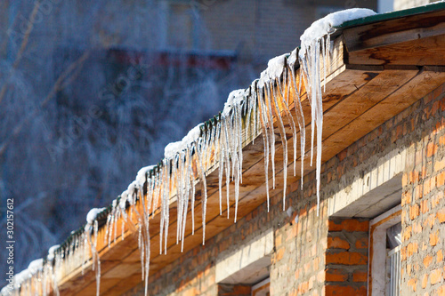 icicles which are hanging down from a roof
