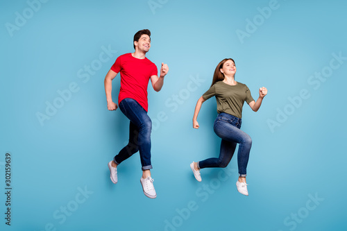 Full body photo of two spouses relax rest jump run wear casual style outfit isolated over blue color background
