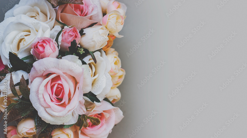 Bouquet of artificial pastel color flowers on gray background, top view with copy space - obrazy, fototapety, plakaty 