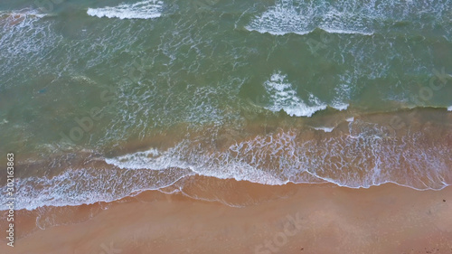  Aerial Dron Shot of the Baltic Sea Costline With Waves View From Above. Sea Waves Over a Sandy Beach.top View of Sea Waves Foaming and Splashing, Big Waves From Above  photo