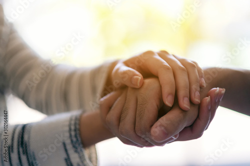 A man and a woman holding each other hands for comfort and sympathy photo