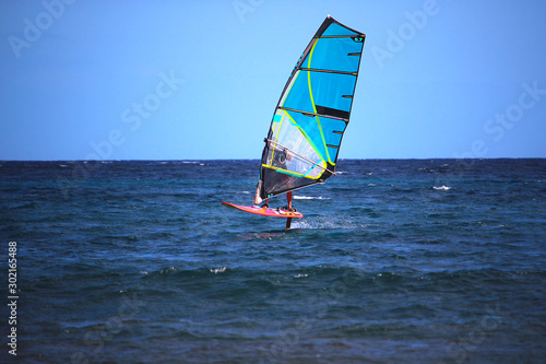 Windsurfer using a foilboard causing the board to leave the surface of the water (El Medano, Spain)