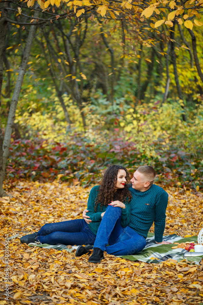 Couple in sweaters in the autumn park Couple in sweaters in the autumn park
