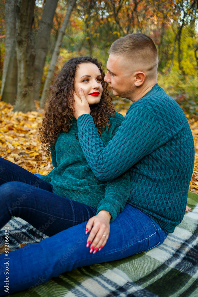 Couple in sweaters in the autumn park Couple in sweaters in the autumn park