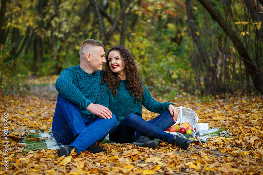 Couple in sweaters in the autumn park Couple in sweaters in the autumn park