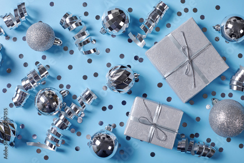 Gift boxes with christmas balls on blue bsckground.