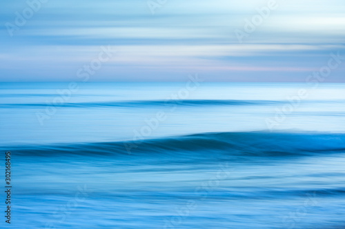 A dreamy blue blurred effect abstract of the sea at sunset created by using a slow shutter speed. Taken at Brighton, East Sussex.