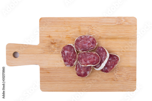 sliced sausage on the table isolated on white