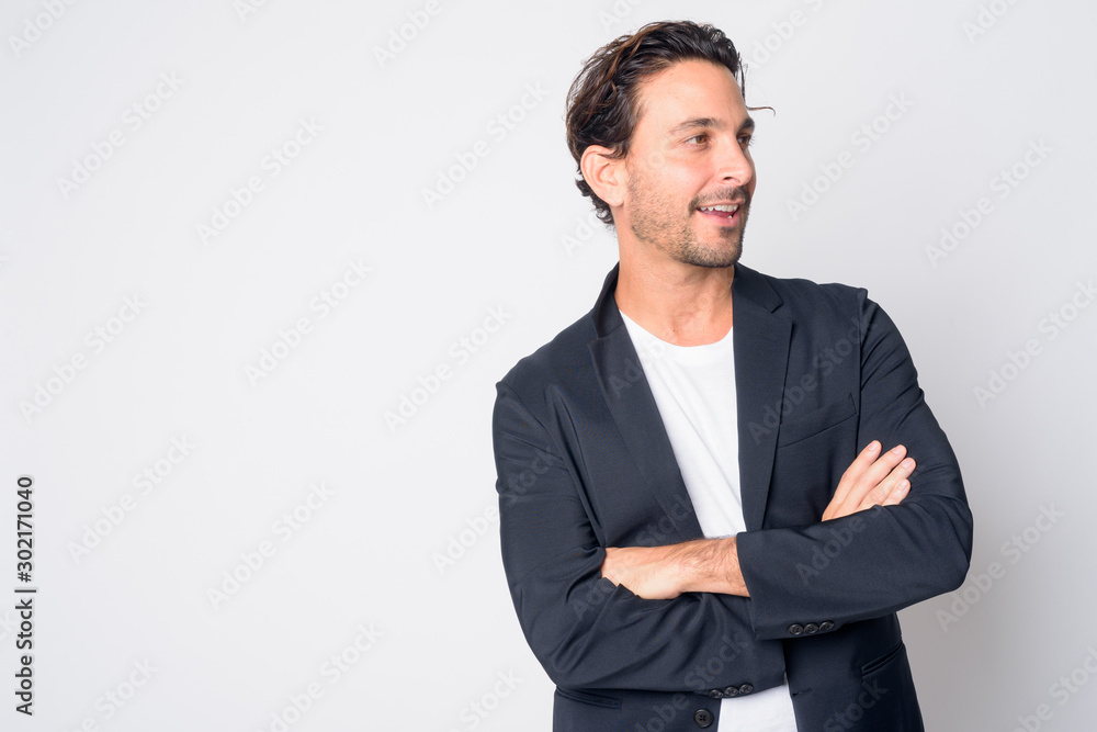 Portrait of happy handsome Hispanic businessman thinking with arms crossed Portrait of happy handsome Hispanic businessman thinking with arms crossed