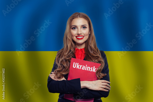Ukraine concept. Pretty smiling brunette woman against the Ukrai photo