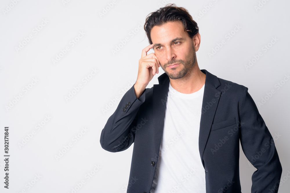 Portrait of confused Hispanic businessman thinking and scratching head Portrait of confused Hispanic businessman thinking and scratching head