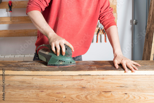 woman sanding a restored wood