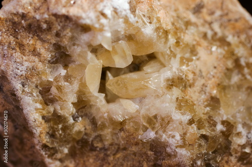 Natural quartz crystals grow from a stone block close up