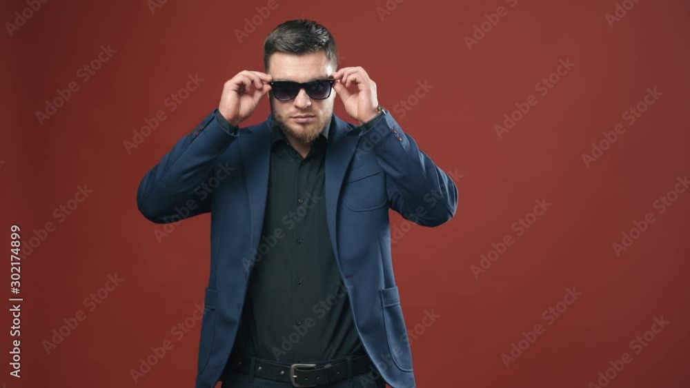Handsome young businessman. Positive businessman wearing glasses in studio Handsome young businessman. Positive businessman wearing glasses in studio